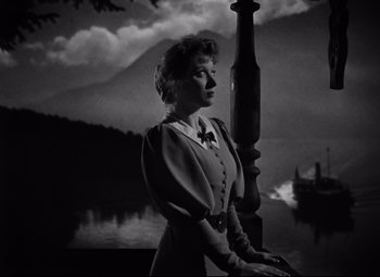 Movie still from “Goodbye, Mr. Chips” (1939), directed by Sam Wood – A woman standing in front of a body of water; Medium shot, Low angle