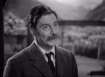 Movie still from “Goodbye, Mr. Chips” (1939), directed by Sam Wood – A man with a mustache and a suit and tie; Close Up shot, Low angle