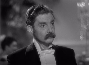 Movie still from “Goodbye, Mr. Chips” (1939), directed by Sam Wood – A black and white photo of a man with a mustache; Close Up shot, High angle