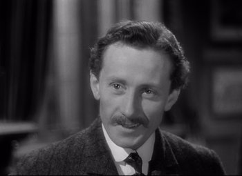Movie still from “Goodbye, Mr. Chips” (1939), directed by Sam Wood – An old black and white photo of a man with a mustache; Close Up shot, High angle