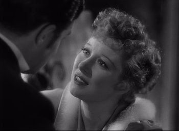 Movie still from “Goodbye, Mr. Chips” (1939), directed by Sam Wood – An old black and white photo of a man and a woman; Close Up shot, Over the shoulder angle