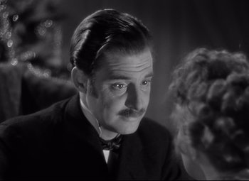 Movie still from “Goodbye, Mr. Chips” (1939), directed by Sam Wood – A black and white photo of a man and a woman; Close Up shot, Over the shoulder angle