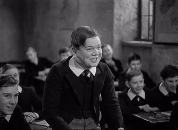 Movie still from “Goodbye, Mr. Chips” (1939), directed by Sam Wood – Black and white photograph of students in a class room; Medium shot, Over the shoulder angle