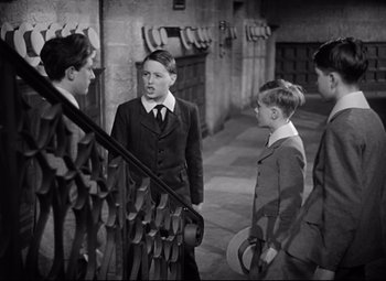 Movie still from “Goodbye, Mr. Chips” (1939), directed by Sam Wood – A black and white photo of a group of young men standing next to each other; Medium shot, High angle