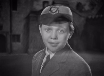 Movie still from “Goodbye, Mr. Chips” (1939), directed by Sam Wood – A black and white photo of a young boy wearing a hat; Close Up shot, High angle