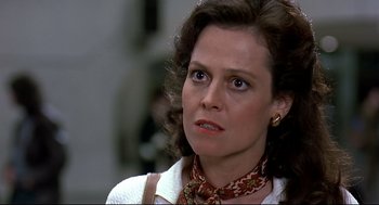 Movie still from “Gorillas in the Mist” (1988), directed by Michael Apted – A person wearing a neck scarf; Close Up shot, Over the shoulder angle