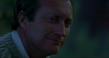 Movie still from “Gorillas in the Mist” (1988), directed by Michael Apted – A man's face in the dark; Close Up shot, Low angle