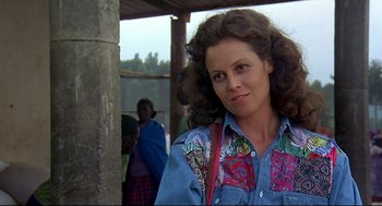 Movie still from “Gorillas in the Mist” (1988), directed by Michael Apted – A person wearing a denim shirt; Close Up shot, Over the shoulder angle