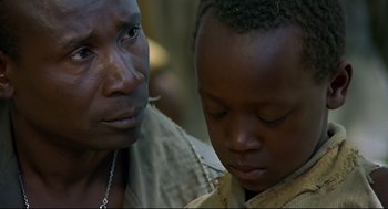 Movie still from “Gorillas in the Mist” (1988), directed by Michael Apted – An older man and a young boy looking at each other; Close Up shot, Over the shoulder angle