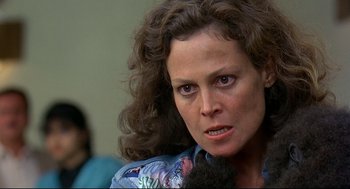 Movie still from “Gorillas in the Mist” (1988), directed by Michael Apted – A person with curly hair; Close Up shot, Low angle