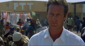 Movie still from “Gorillas in the Mist” (1988), directed by Michael Apted – A person wearing a white shirt; Close Up shot, Over the shoulder angle