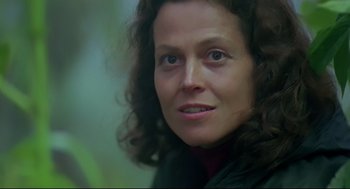 Movie still from “Gorillas in the Mist” (1988), directed by Michael Apted – A woman's face in a green jacket; Close Up shot, Low angle