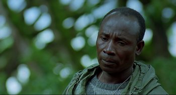 Movie still from “Gorillas in the Mist” (1988), directed by Michael Apted – A person wearing a jacket; Close Up shot, Low angle