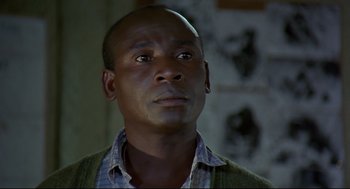 Movie still from “Gorillas in the Mist” (1988), directed by Michael Apted – A person looking up at the sky; Close Up shot, Low angle