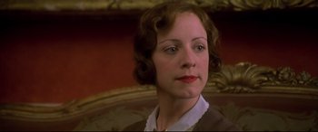 Movie still from “Gosford Park” (2001), directed by Robert Altman – A woman in a brown dress is looking to her left; Close Up shot, Low angle