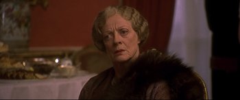Movie still from “Gosford Park” (2001), directed by Robert Altman – An older woman in a brown dress with a fur collar; Close Up shot, Low angle