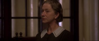 Movie still from “Gosford Park” (2001), directed by Robert Altman – An older woman wearing a black and white dress; Close Up shot, Low angle