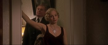 Movie still from “Gosford Park” (2001), directed by Robert Altman – A man and a woman are standing in front of a mirror; Medium shot, Low angle