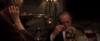 Movie still from “Gosford Park” (2001), directed by Robert Altman – An older man sitting at a table with a plate of food; Close Up shot, High angle