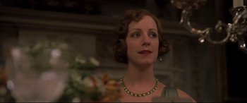 Movie still from “Gosford Park” (2001), directed by Robert Altman – A woman in a green dress looking up; Close Up shot, Low angle