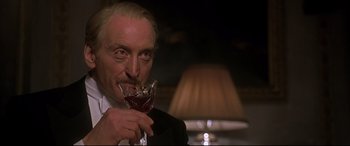 Movie still from “Gosford Park” (2001), directed by Robert Altman – An older man is drinking a glass of wine; Close Up shot, Low angle