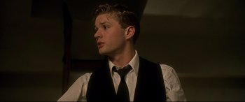 Movie still from “Gosford Park” (2001), directed by Robert Altman – A man in a white shirt and a black tie; Close Up shot, Low angle
