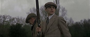 Movie still from “Gosford Park” (2001), directed by Robert Altman – A man holding a gun while standing next to another man; Close Up shot, Low angle