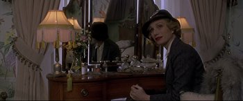 Movie still from “Gosford Park” (2001), directed by Robert Altman – A woman sitting in front of a mirror in front of a man; Close Up shot, Over the shoulder angle