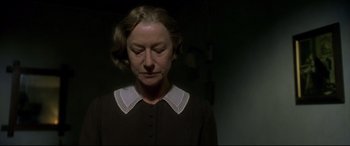Movie still from “Gosford Park” (2001), directed by Robert Altman – An older woman in a dark room with her eyes wide open; Close Up shot, Low angle