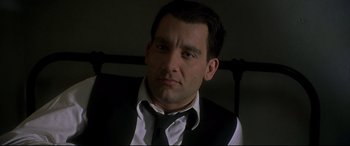 Movie still from “Gosford Park” (2001), directed by Robert Altman – A person wearing a suit and tie; Close Up shot, Low angle