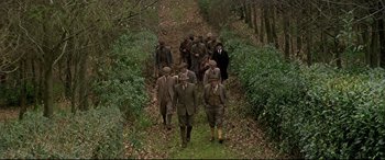 Movie still from “Gosford Park” (2001), directed by Robert Altman – A group of men walking down a path in the woods; Wide shot, High angle