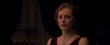 Movie still from “Gosford Park” (2001), directed by Robert Altman – An older woman wearing a red dress and a diamond necklace; Close Up shot, Low angle