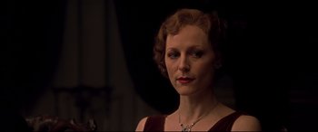 Movie still from “Gosford Park” (2001), directed by Robert Altman – A woman in a red dress is looking at the camera; Close Up shot, Low angle