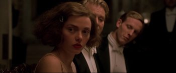 Movie still from “Gosford Park” (2001), directed by Robert Altman – A man and a woman standing next to each other in front of another man; Close Up shot, Over the shoulder angle
