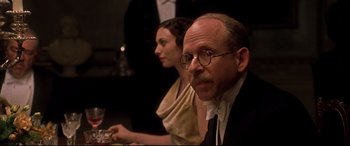 Movie still from “Gosford Park” (2001), directed by Robert Altman – A man and a woman sitting at a dinner table; Close Up shot, Over the shoulder angle