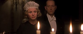 Movie still from “Gosford Park” (2001), directed by Robert Altman – A man and a woman standing in front of lit candles; Close Up shot, Low angle