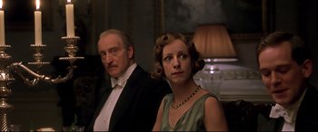 Movie still from “Gosford Park” (2001), directed by Robert Altman – A man and a woman standing next to each other in a room; Close Up shot, Low angle