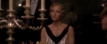 Movie still from “Gosford Park” (2001), directed by Robert Altman – An older woman wearing a black and white dress; Close Up shot, Low angle