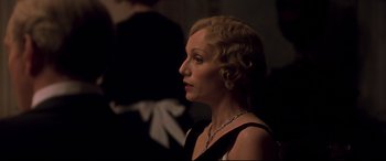 Movie still from “Gosford Park” (2001), directed by Robert Altman – An older woman in a black dress looking to her left; Close Up shot, Over the shoulder angle
