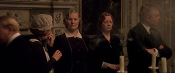Movie still from “Gosford Park” (2001), directed by Robert Altman – A group of women standing next to each other in a room; Medium shot, Low angle