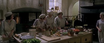 Movie still from “Gosford Park” (2001), directed by Robert Altman – A group of people in a kitchen preparing food; Wide shot, High angle