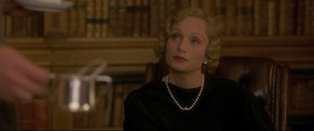 Movie still from “Gosford Park” (2001), directed by Robert Altman – An older woman wearing a black dress and a pearl necklace; Close Up shot, Low angle