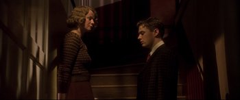 Movie still from “Gosford Park” (2001), directed by Robert Altman – A man and a woman standing next to each other; Medium shot, Low angle