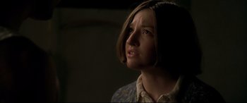 Movie still from “Gosford Park” (2001), directed by Robert Altman – A young woman with short brown hair is looking up; Close Up shot, Over the shoulder angle