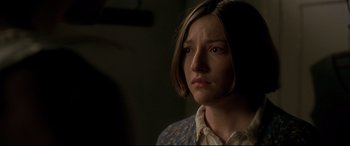 Movie still from “Gosford Park” (2001), directed by Robert Altman – A woman with short brown hair is looking at the camera; Close Up shot, Over the shoulder angle