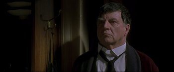 Movie still from “Gosford Park” (2001), directed by Robert Altman – A person wearing a suit and tie; Close Up shot, Low angle