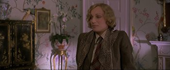 Movie still from “Gosford Park” (2001), directed by Robert Altman – A woman with blonde hair wearing a suit and tie; Close Up shot, Over the shoulder angle