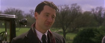 Movie still from “Gosford Park” (2001), directed by Robert Altman – A person wearing a suit and tie; Close Up shot, Low angle