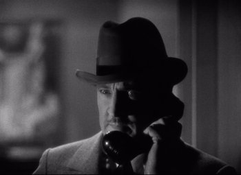 Movie still from “Grand Hotel” (1932), directed by Edmund Goulding – A black and white photo of a man talking on a phone; Close Up shot, Low angle
