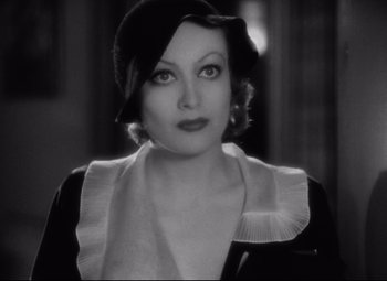 Movie still from “Grand Hotel” (1932), directed by Edmund Goulding – A black - and - white photo of a woman in a hat; Close Up shot, Over the shoulder angle